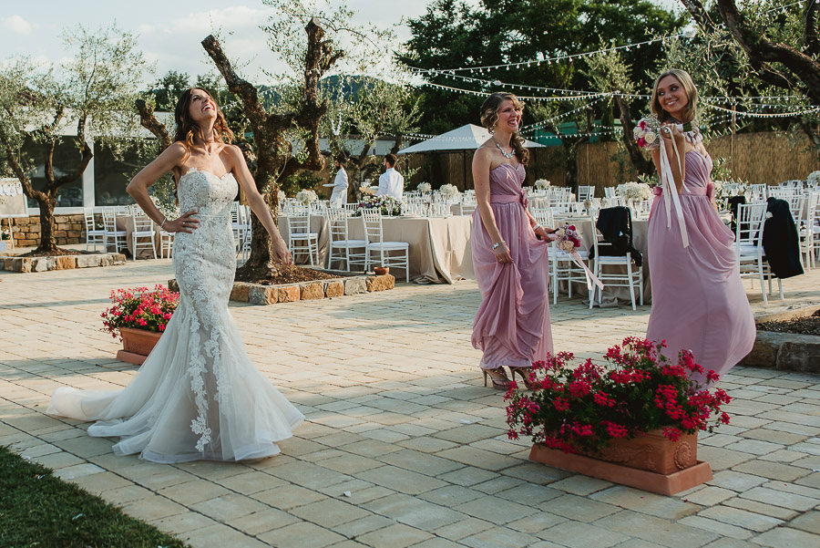 italian style outdoor wedding ceremony, having fun with bridesma