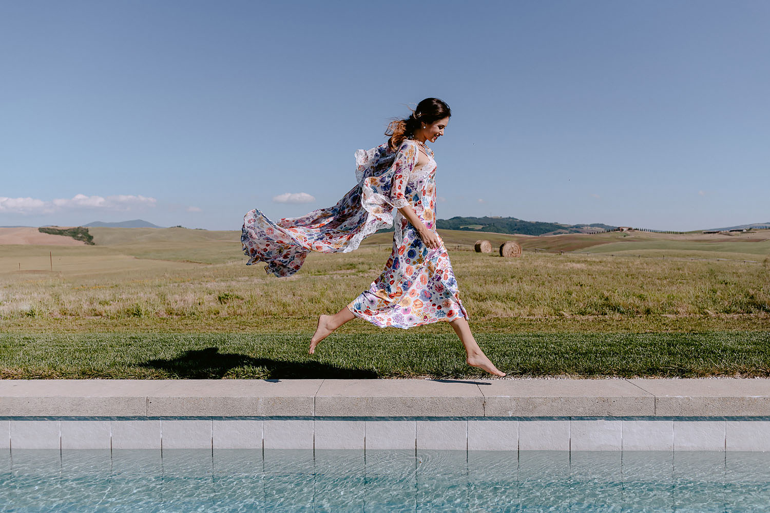 editorial Intimate Wedding Inspiration in Tuscan Rolling Hills bride in petticoat flying on pool