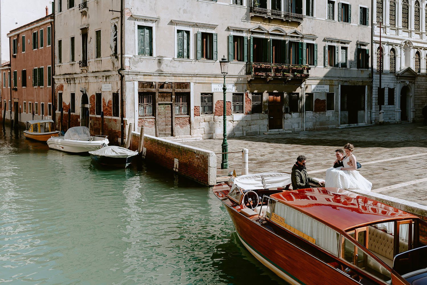 wedding photographer venice elopement photography bride water taxi ride glossy rooftop