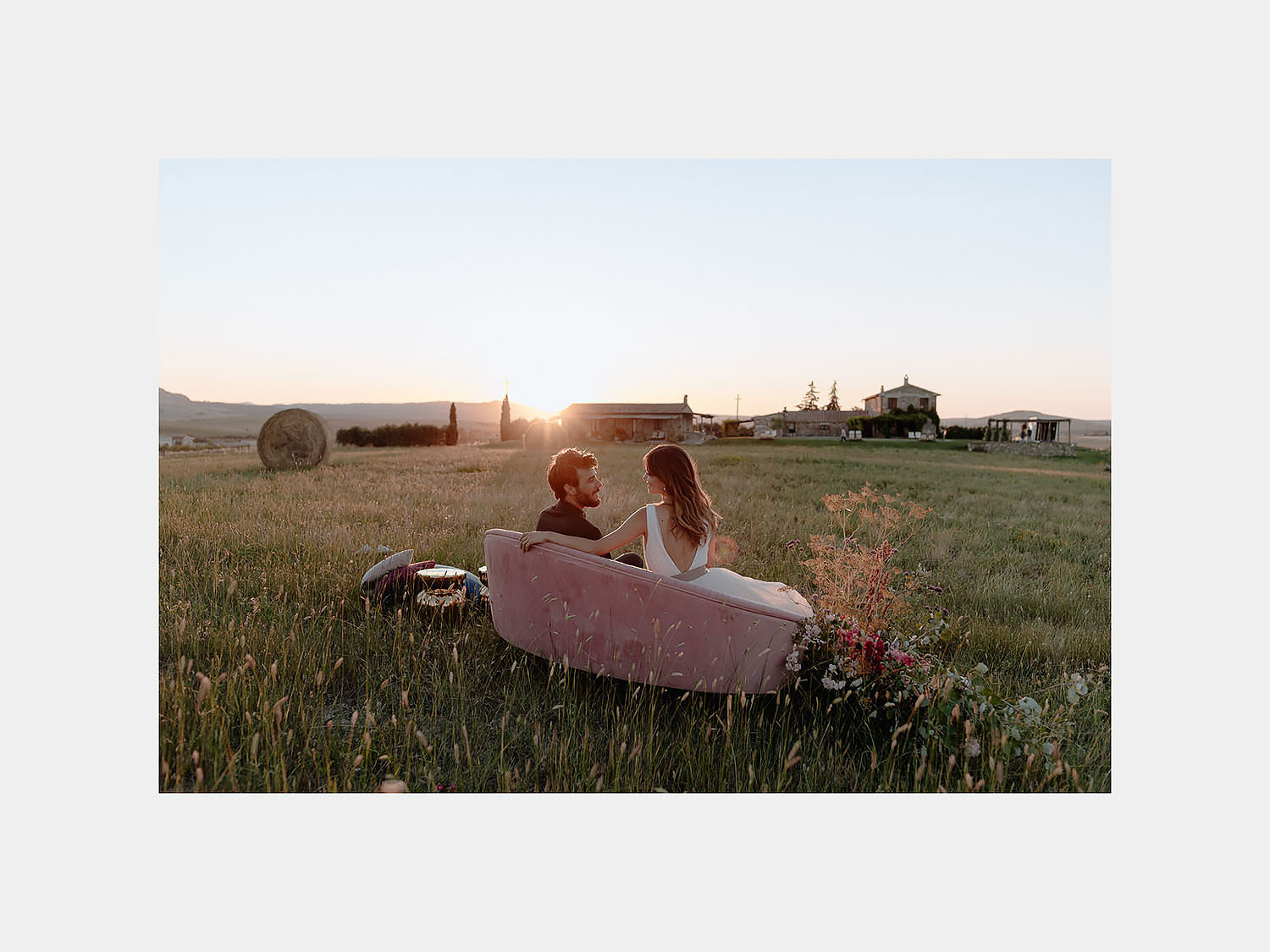 intimate Wedding Inspiration in Tuscan Rolling Hills bride groom sunset tuscan field sofa fascion vibe